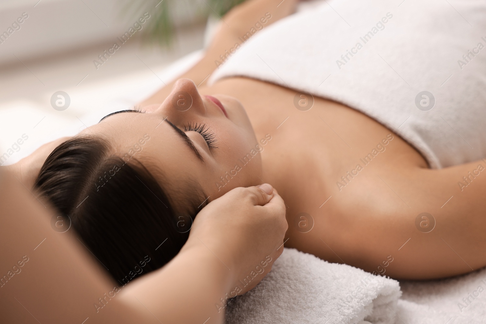 Photo of Attractive woman enjoying face massage, closeup. Beauty procedure