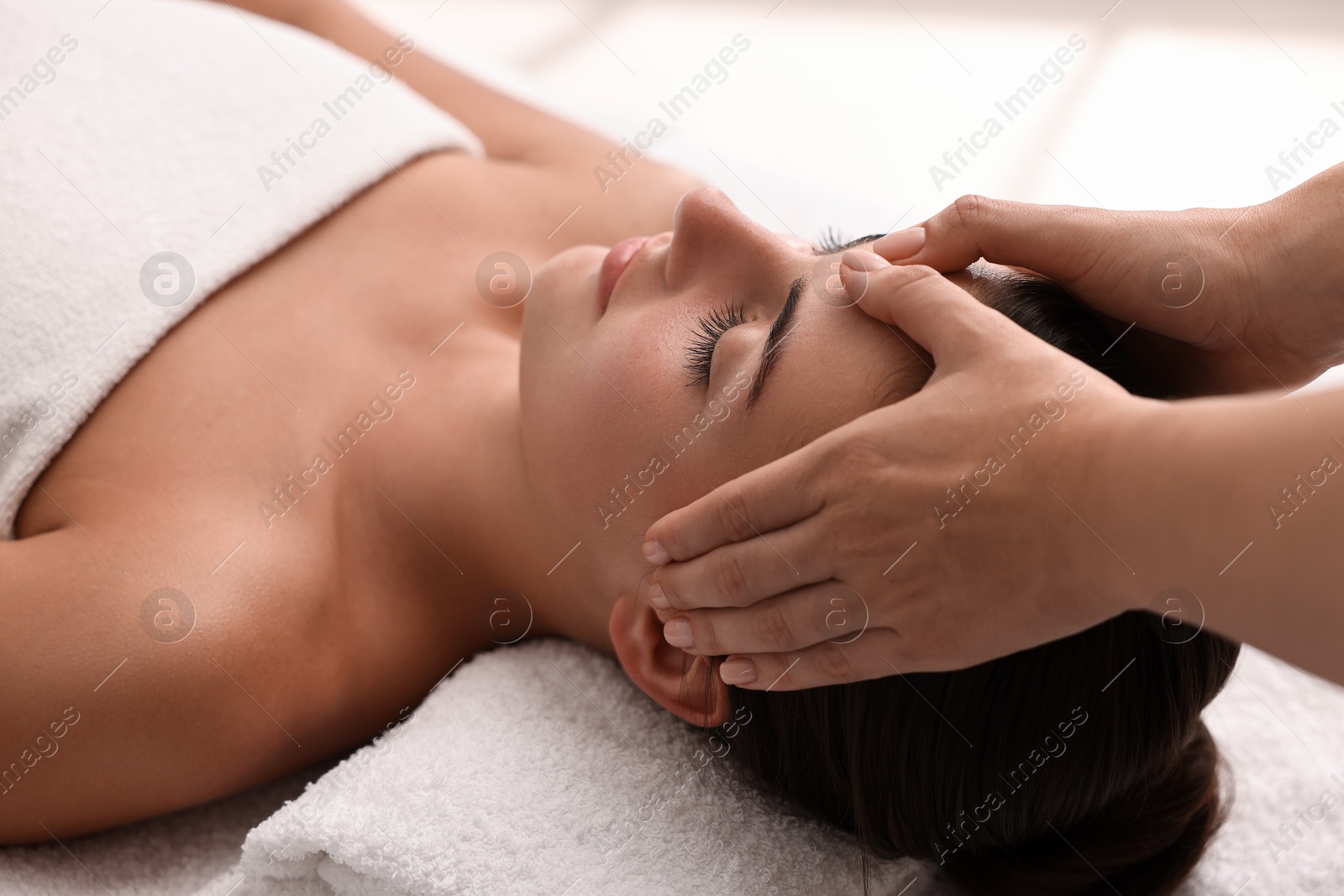 Photo of Attractive woman enjoying face massage, closeup. Beauty procedure