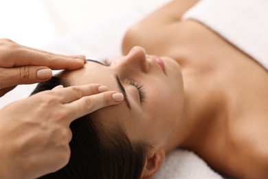 Photo of Attractive woman enjoying face massage, closeup. Beauty procedure