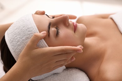 Photo of Attractive woman enjoying face massage, closeup. Beauty procedure