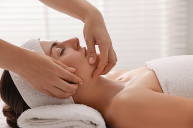 Photo of Attractive woman enjoying face massage, closeup. Beauty procedure