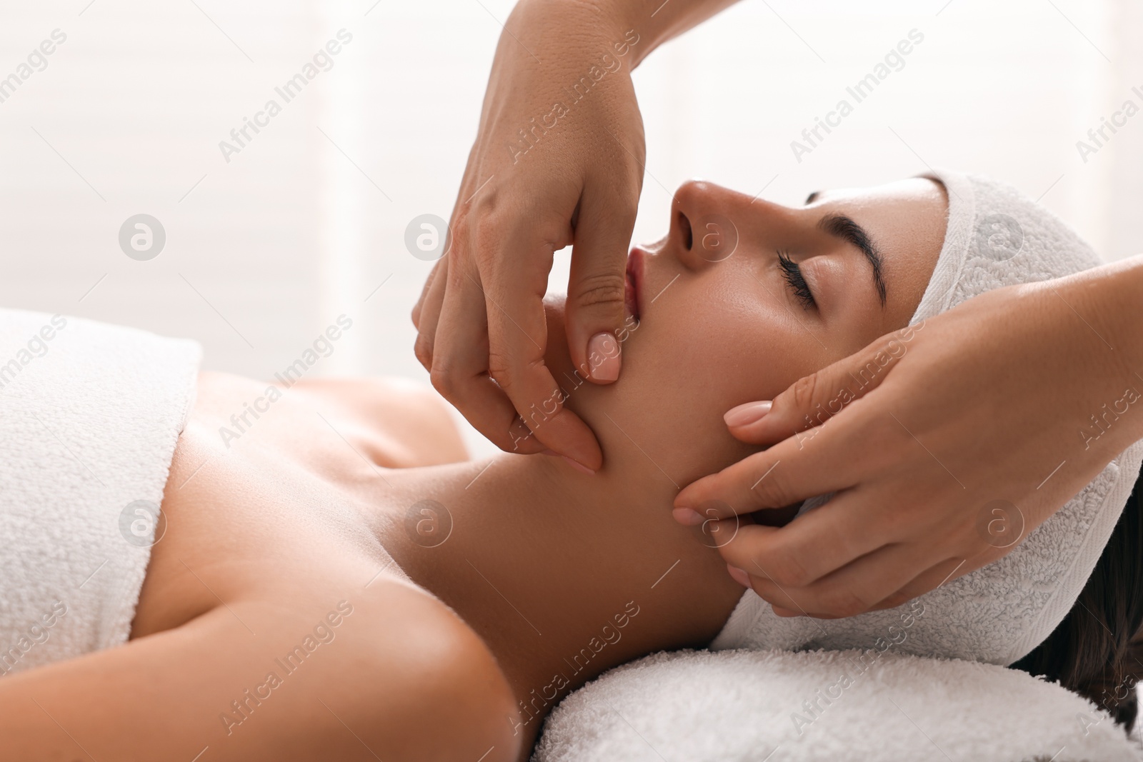 Photo of Attractive woman enjoying face massage, closeup. Beauty procedure