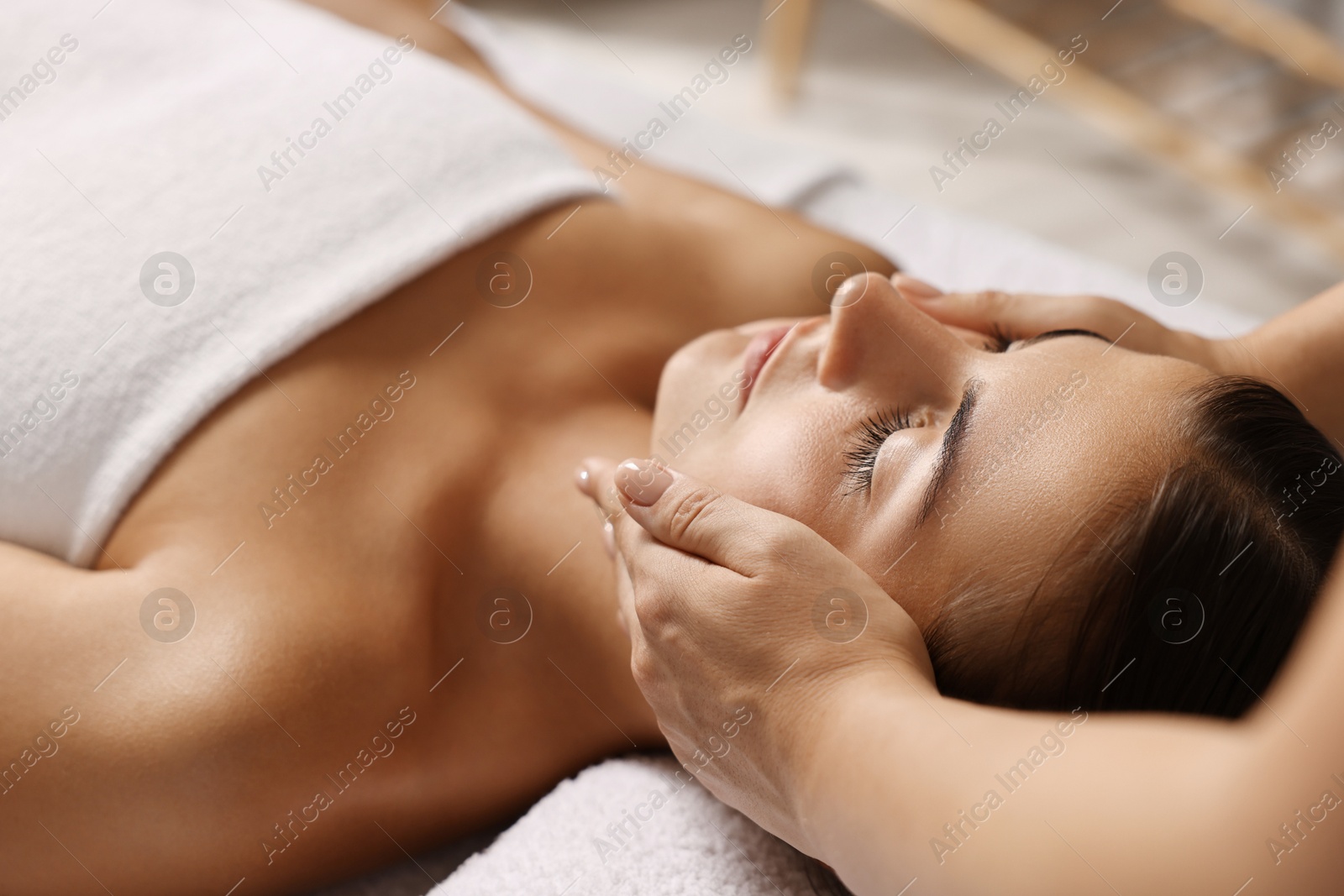 Photo of Attractive woman enjoying face massage, closeup. Beauty procedure