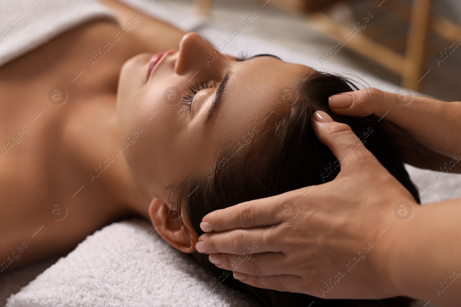 Photo of Attractive woman enjoying face massage, closeup. Beauty procedure