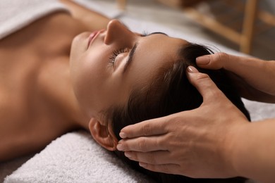 Photo of Attractive woman enjoying face massage, closeup. Beauty procedure