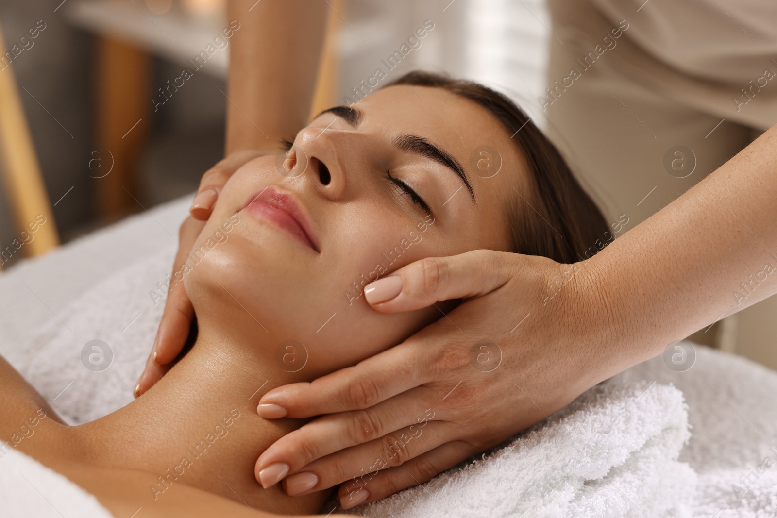 Photo of Attractive woman enjoying face massage, closeup. Beauty procedure