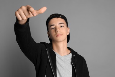 Photo of Portrait of teenage boy on grey background