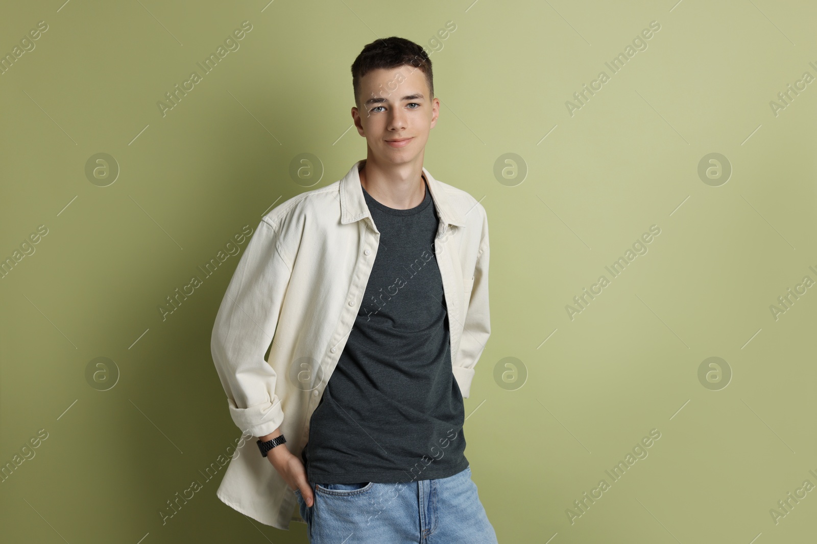 Photo of Portrait of teenage boy on green background