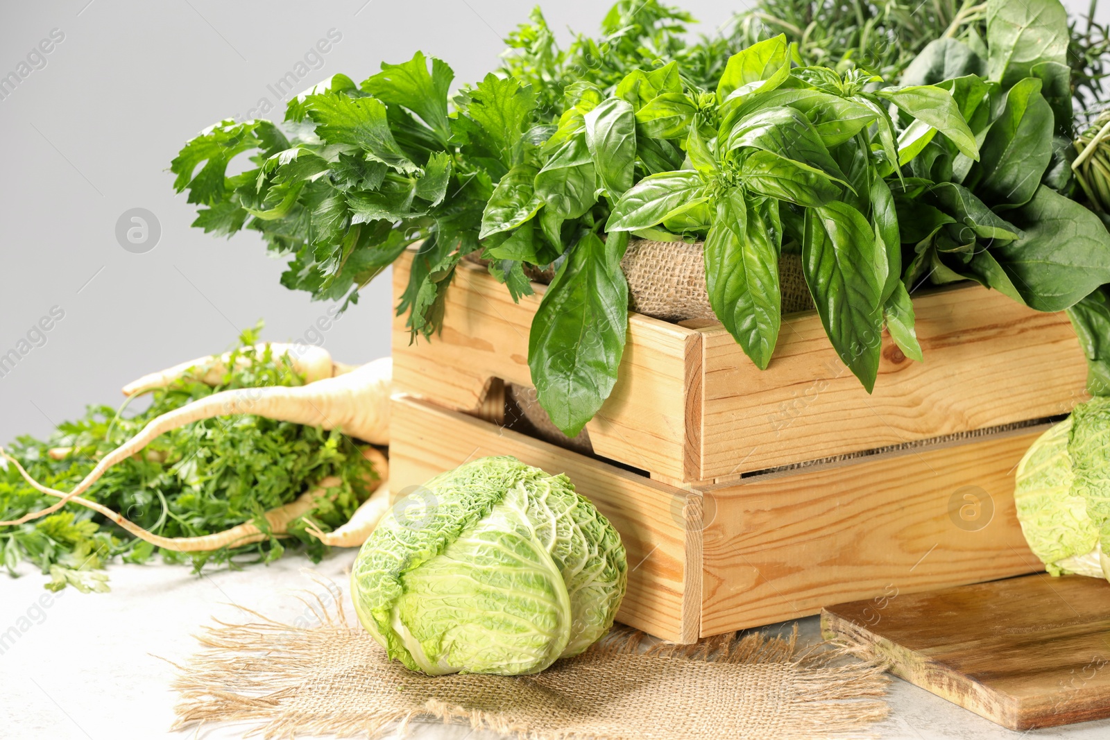 Photo of Different fresh herbs and cabbages on white table, closeup