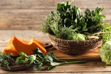 Photo of Different fresh herbs, cabbages and pumpkin on wooden table