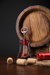 Photo of Wing corkscrew, corks and barrel on wooden table