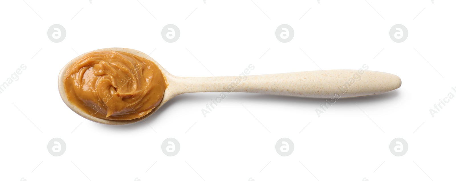 Photo of Tasty peanut butter in spoon isolated on white, top view