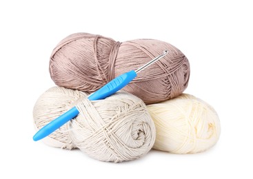 Photo of Skeins of colorful yarns and crochet hook isolated on white