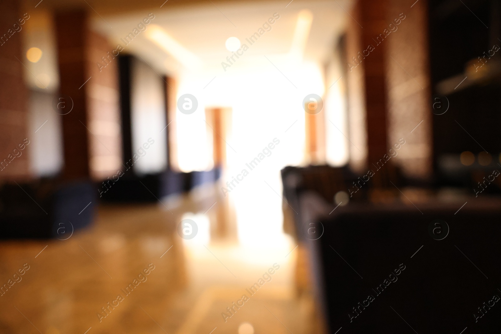 Photo of Blurred view of modern hotel lobby with comfortable furniture