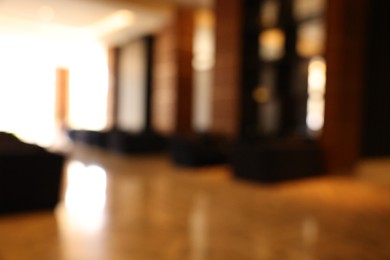 Blurred view of modern hotel lobby with comfortable furniture