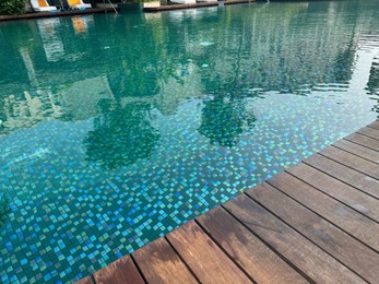 Photo of Outdoor swimming pool with clear water at luxury resort