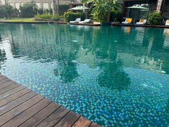 Photo of Outdoor swimming pool with clear water at luxury resort