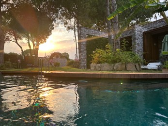 Photo of Outdoor swimming pool with clear water at sunset