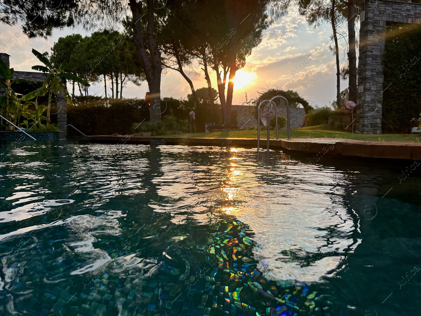 Photo of Outdoor swimming pool with clear water at sunset