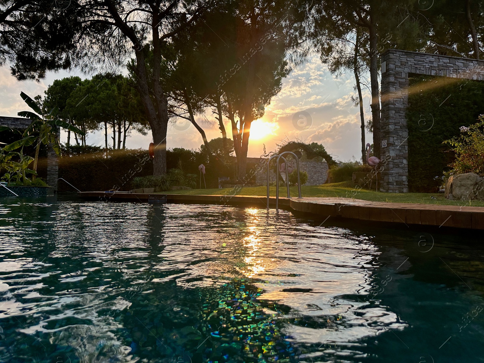 Photo of Outdoor swimming pool with clear water at sunset