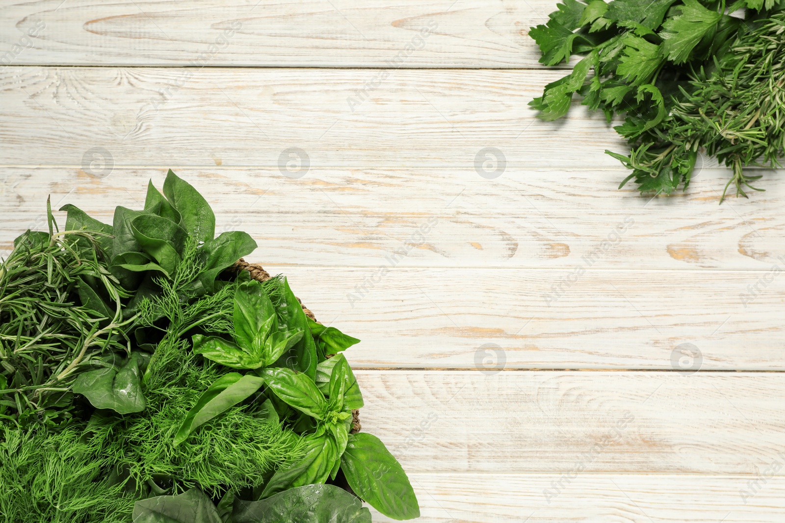 Photo of Different fresh herbs on white wooden table, flat lay. Space for text