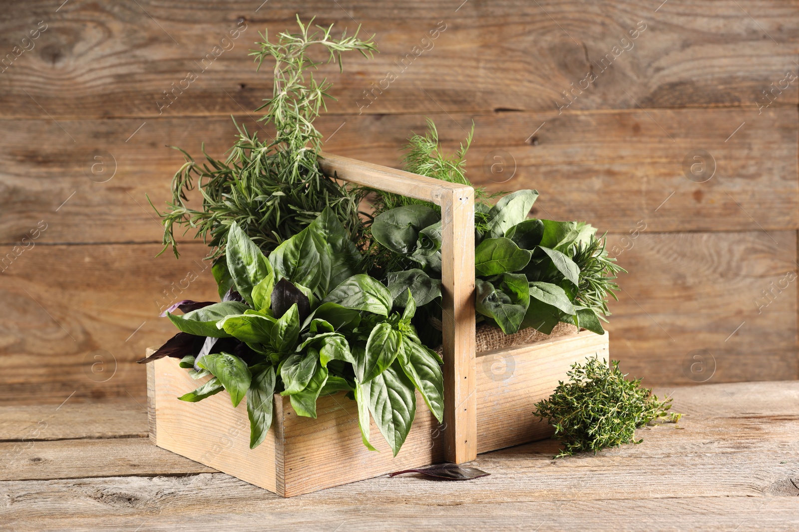 Photo of Different fresh herbs in basket on wooden table