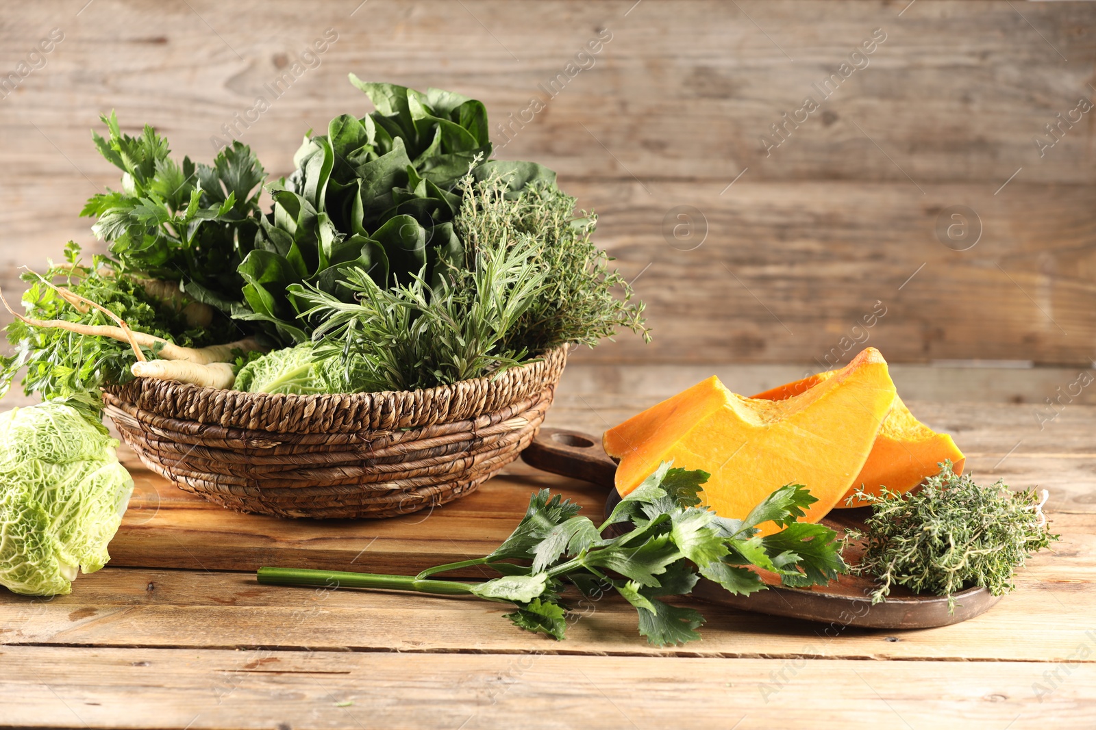 Photo of Different fresh herbs, cabbages and pumpkin on wooden table