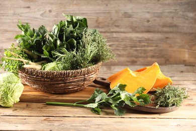 Photo of Different fresh herbs, cabbages and pumpkin on wooden table