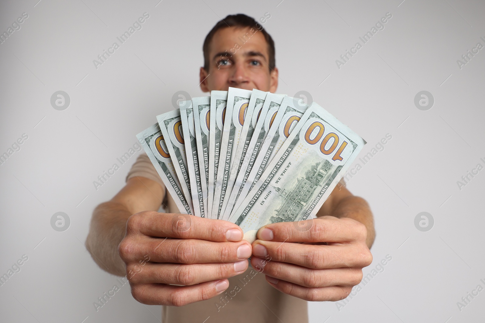 Photo of Man with dollar banknotes on white background, selective focus