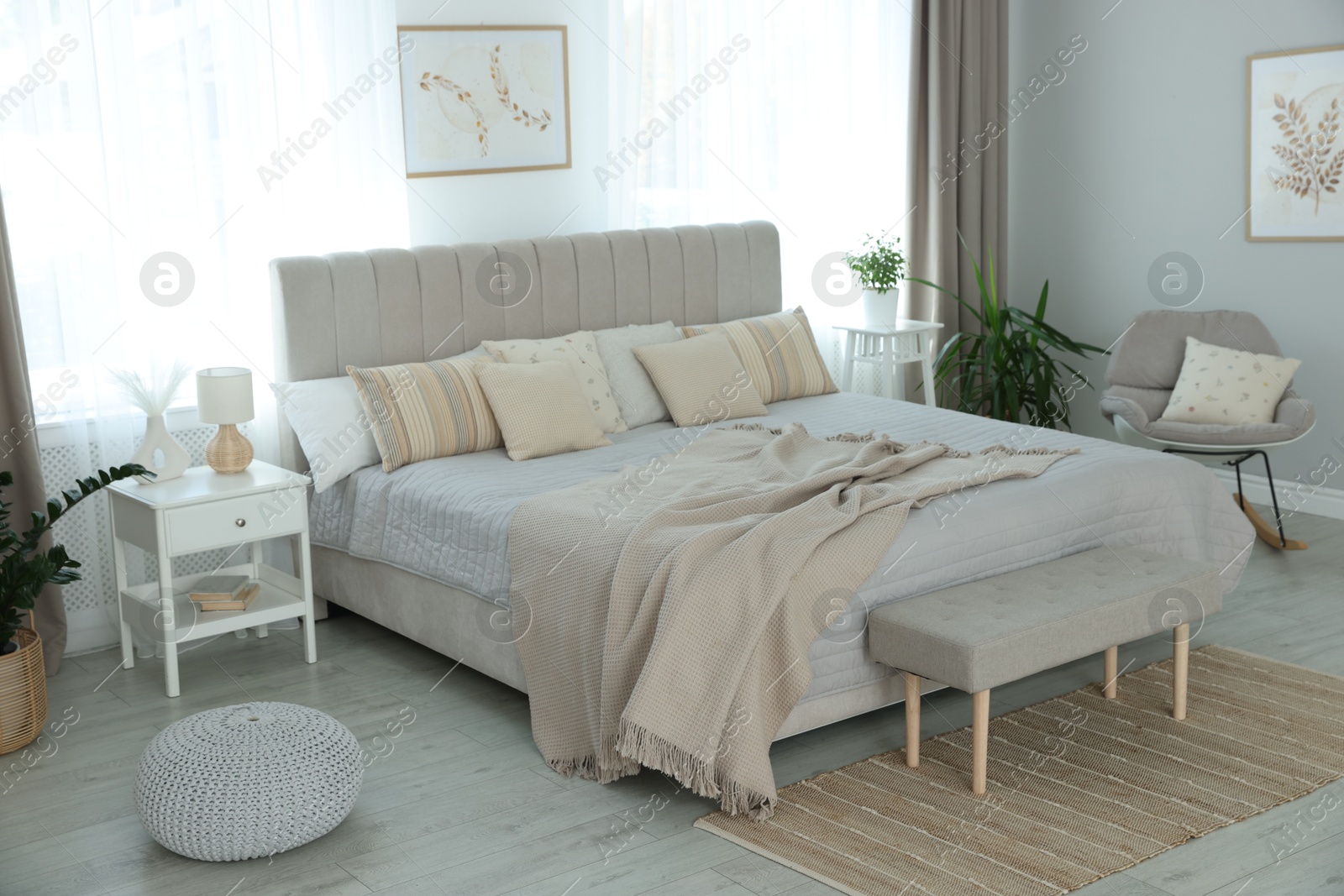 Photo of Big comfortable bed in room. Interior design