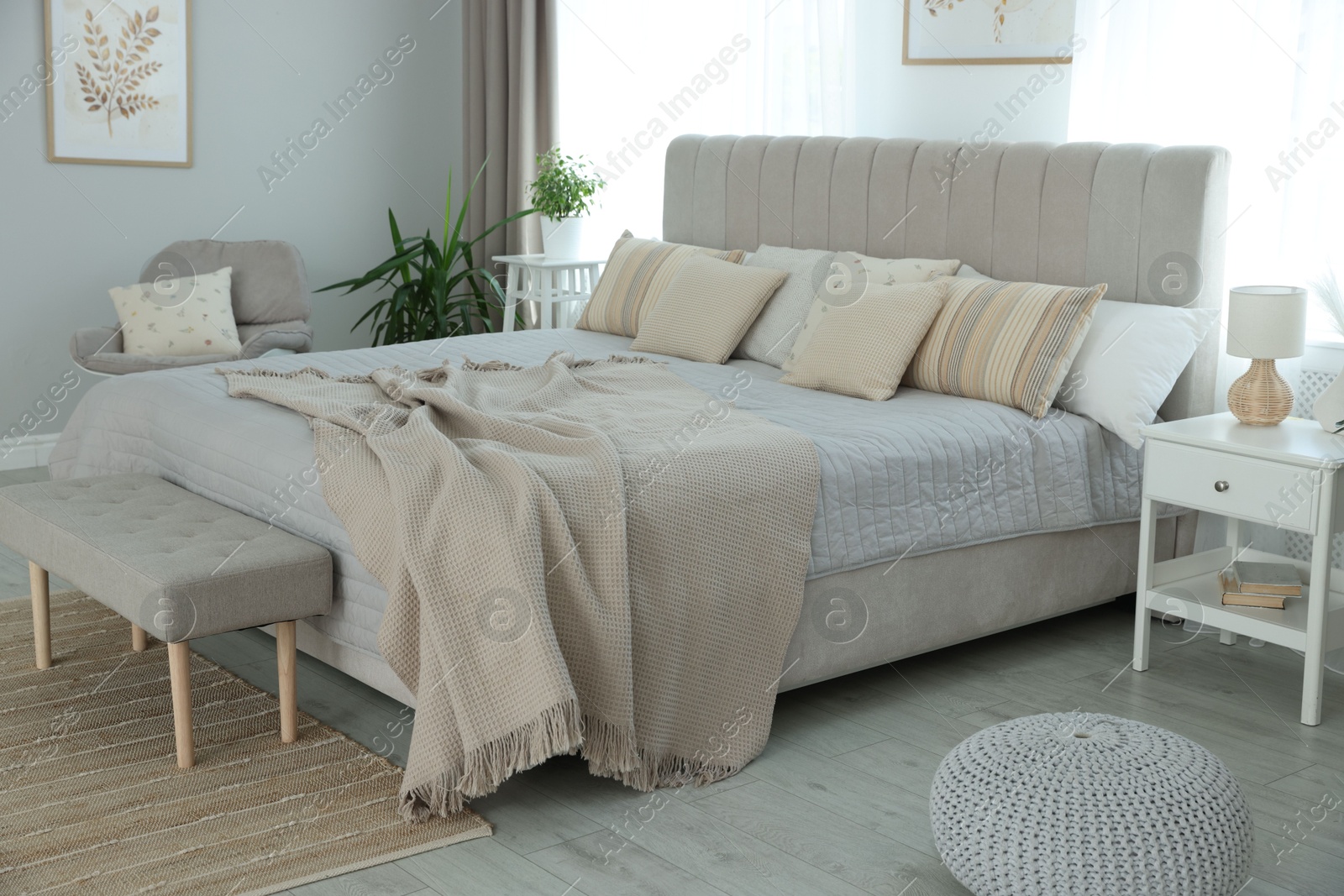 Photo of Big comfortable bed in room. Interior design