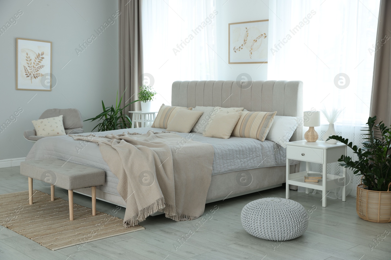 Photo of Big comfortable bed in room. Interior design