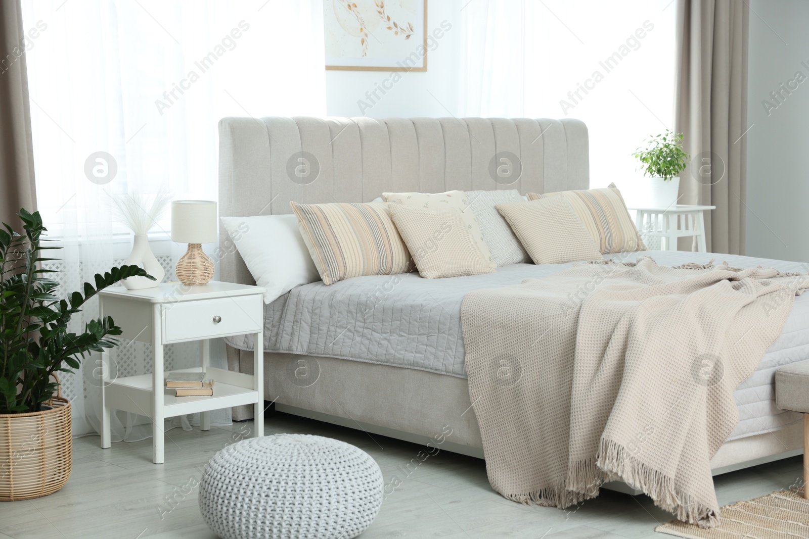 Photo of Big comfortable bed in room. Interior design