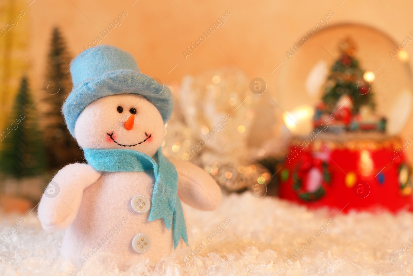 Photo of Funny snowman figure and Christmas decor on artificial snow