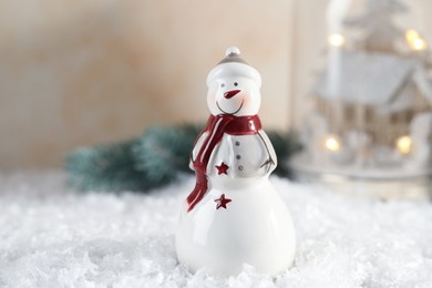 Photo of Funny decorative snowman figure on artificial snow