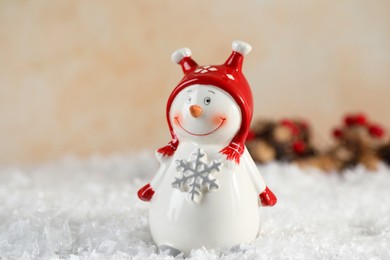 Photo of Funny decorative snowman figure on artificial snow