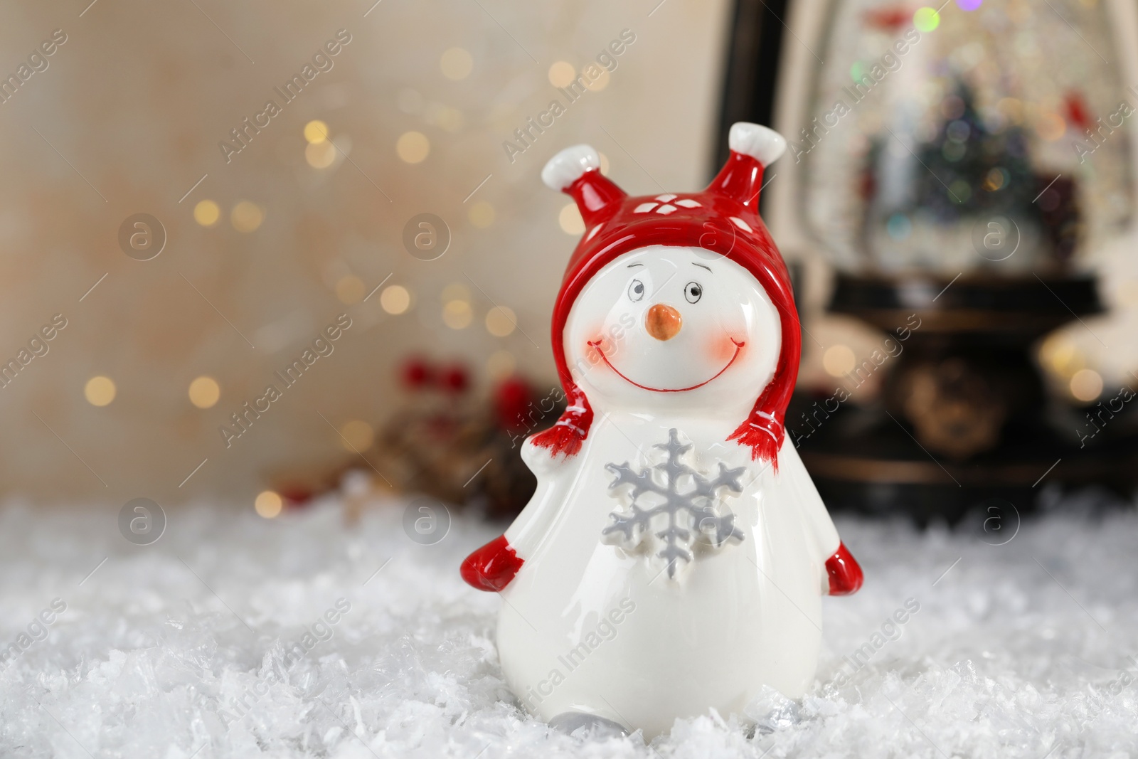 Photo of Funny snowman figure and Christmas decor on artificial snow