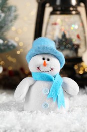 Photo of Funny snowman figure and Christmas decor on artificial snow