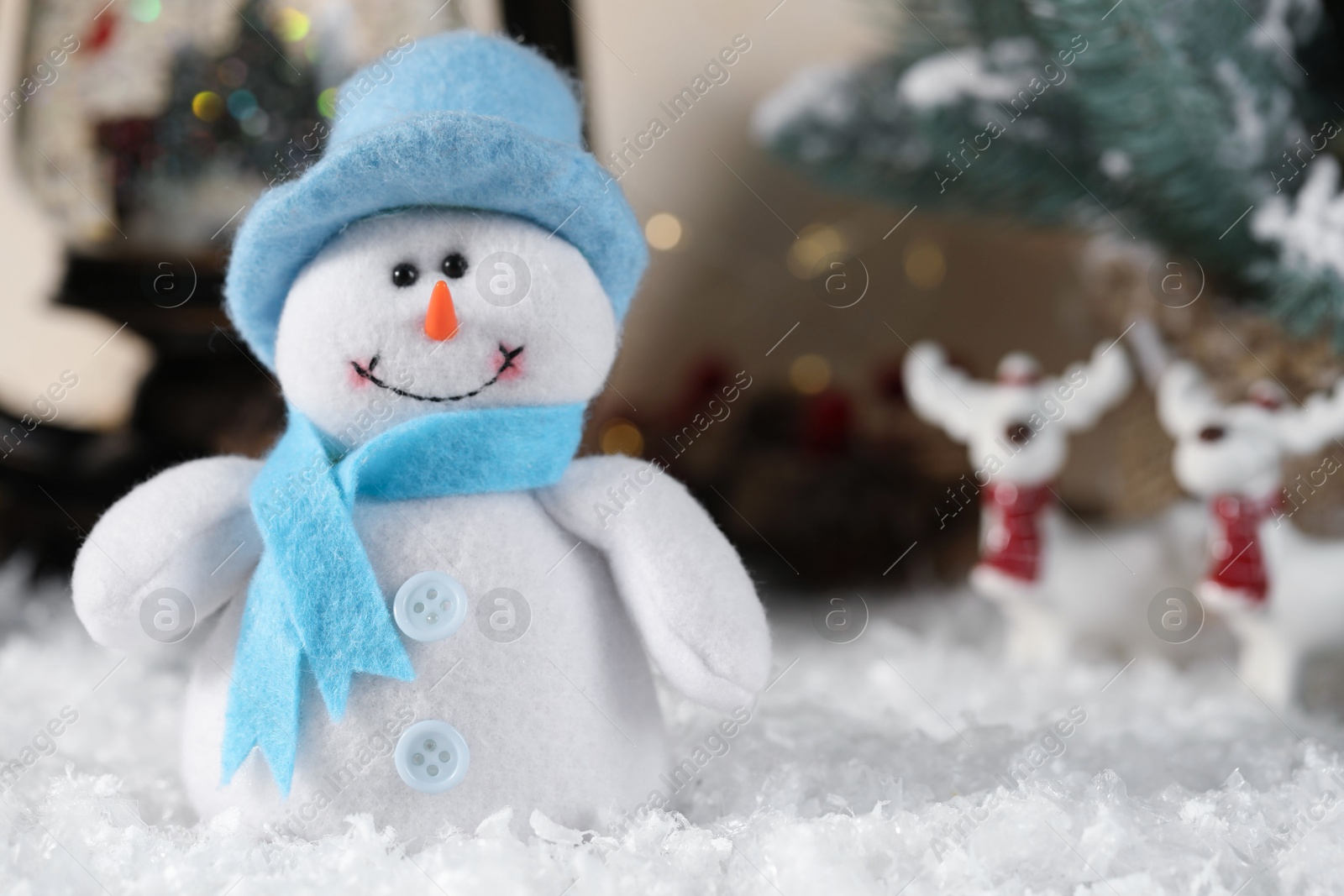 Photo of Funny snowman figure and Christmas decor on artificial snow