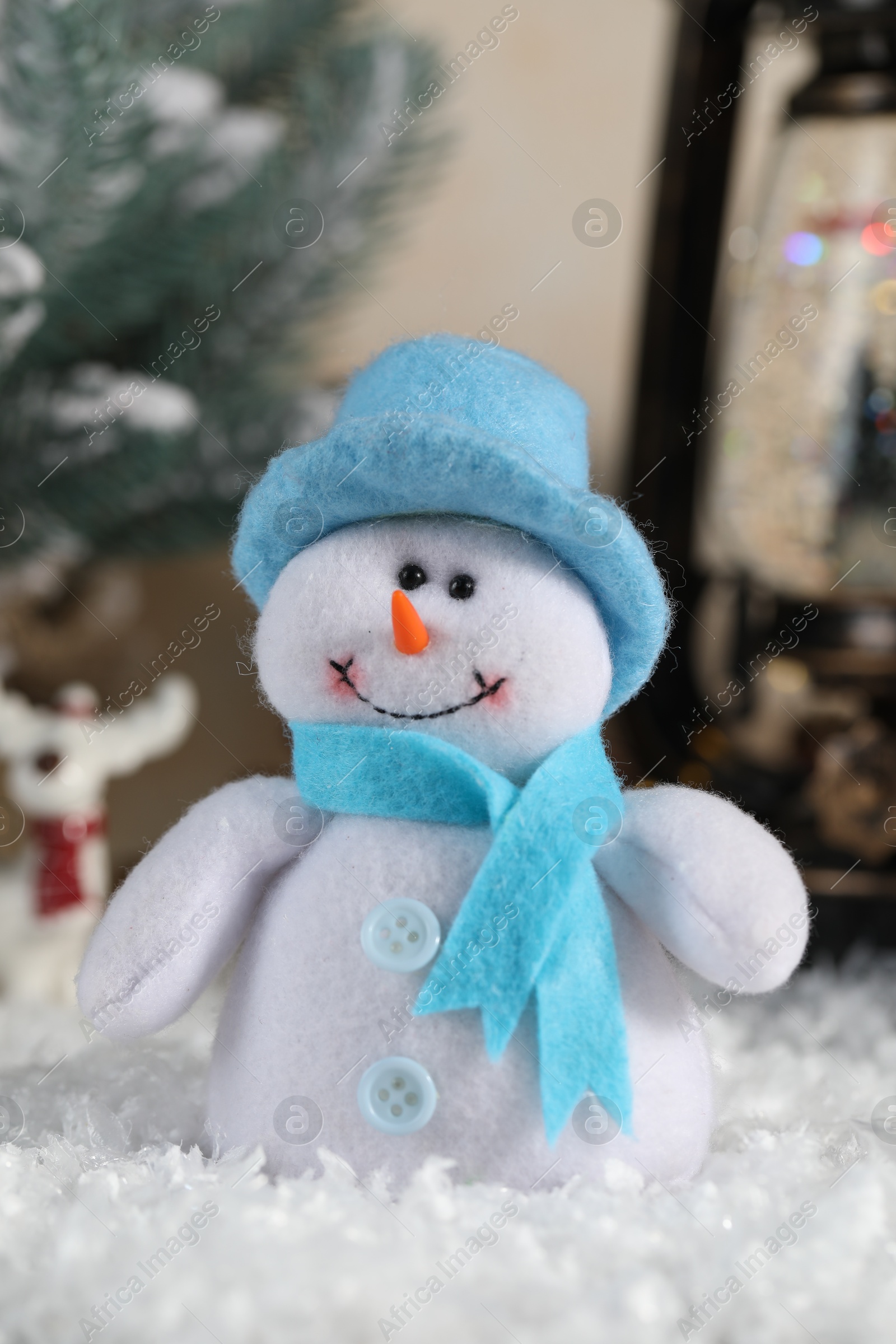 Photo of Funny snowman figure and Christmas decor on artificial snow