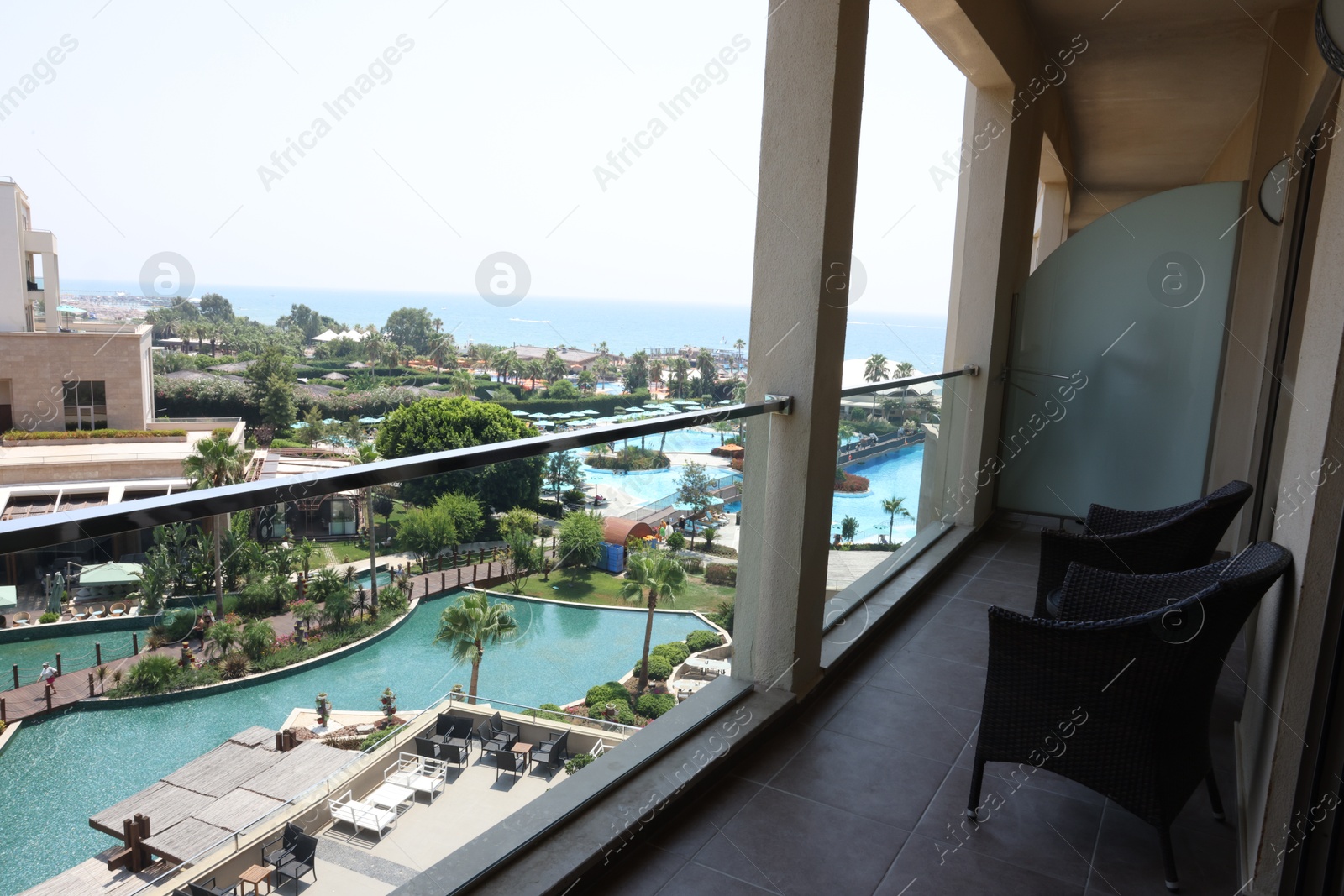 Photo of Belek, Turkey - July 25, 2024: Rattan chairs on hotel balcony in luxury resort