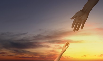 Image of God's help and support. Human reaching for hand from heaven