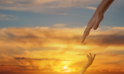 Image of God's help and support. Human reaching for hand from heaven