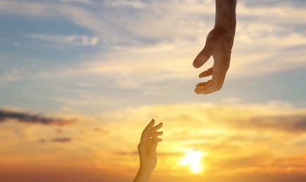 Image of God's help and support. Human reaching for hand from heaven