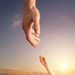 Image of God's help and support. Human reaching for hand from heaven