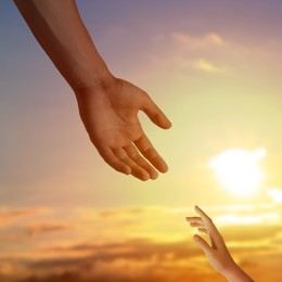 Image of God's help and support. Human reaching for hand from heaven