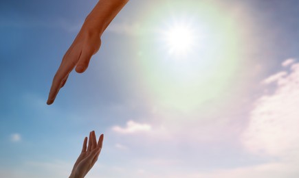 Image of God's help and support. Human reaching for hand from heaven