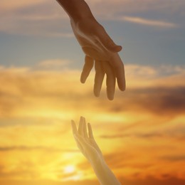 Image of God's help and support. Human reaching for hand from heaven