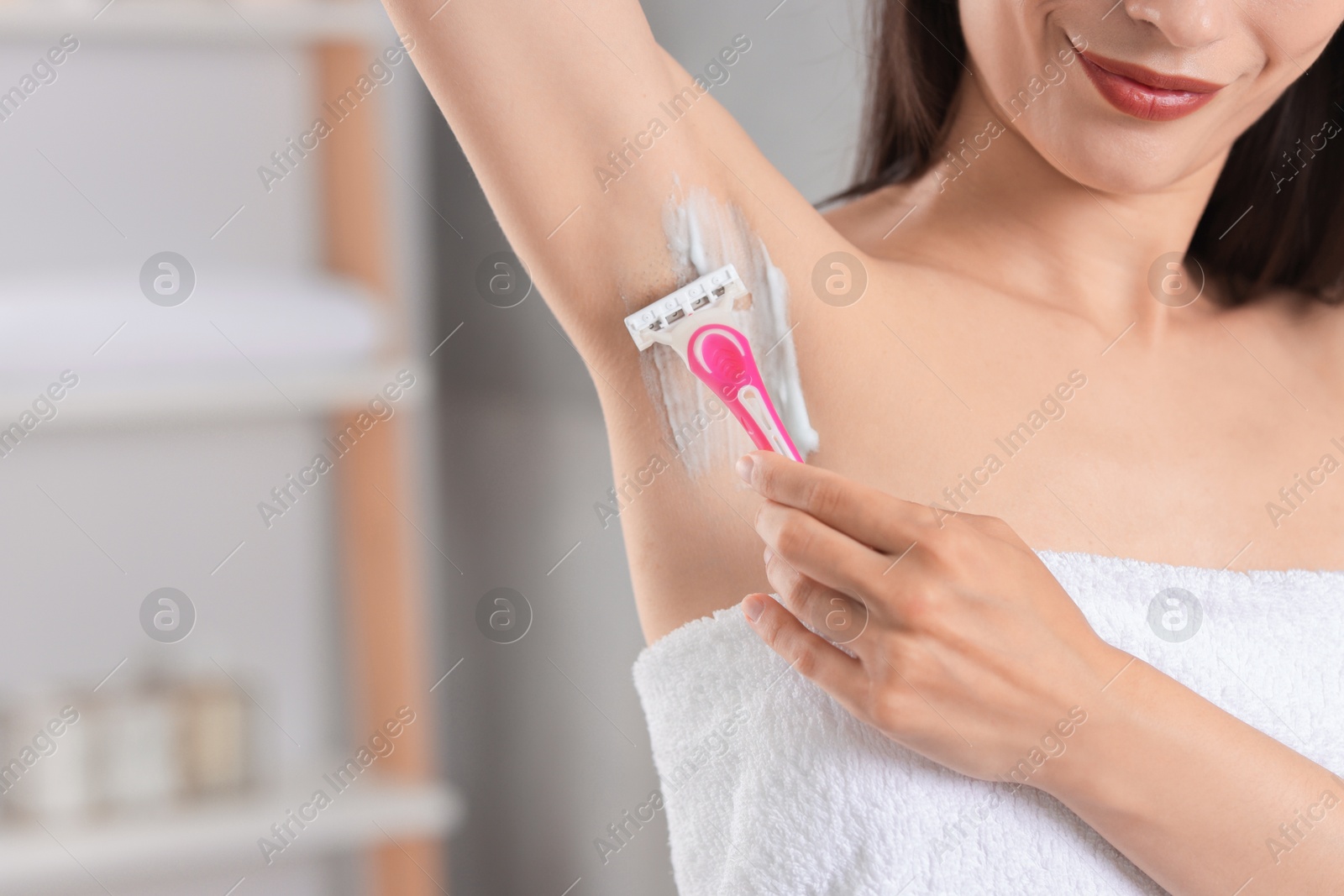 Photo of Woman shaving armpit indoors, closeup. Space for text