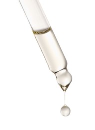 Photo of Essential oil dripping from pipette against white background